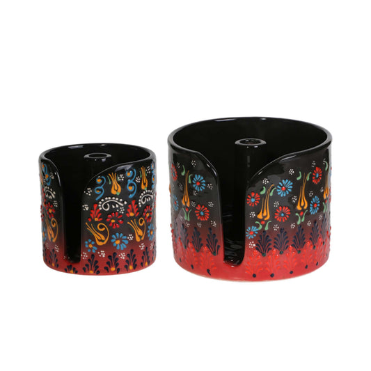 Two black paper towel holders with colorful floral patterns on a white background