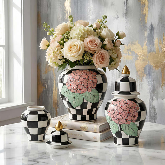 Decorative jars with floral designs on a marble surface