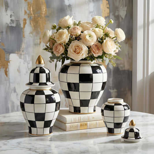Decorative black and white checkered jars with a floral arrangement on a marble surface.