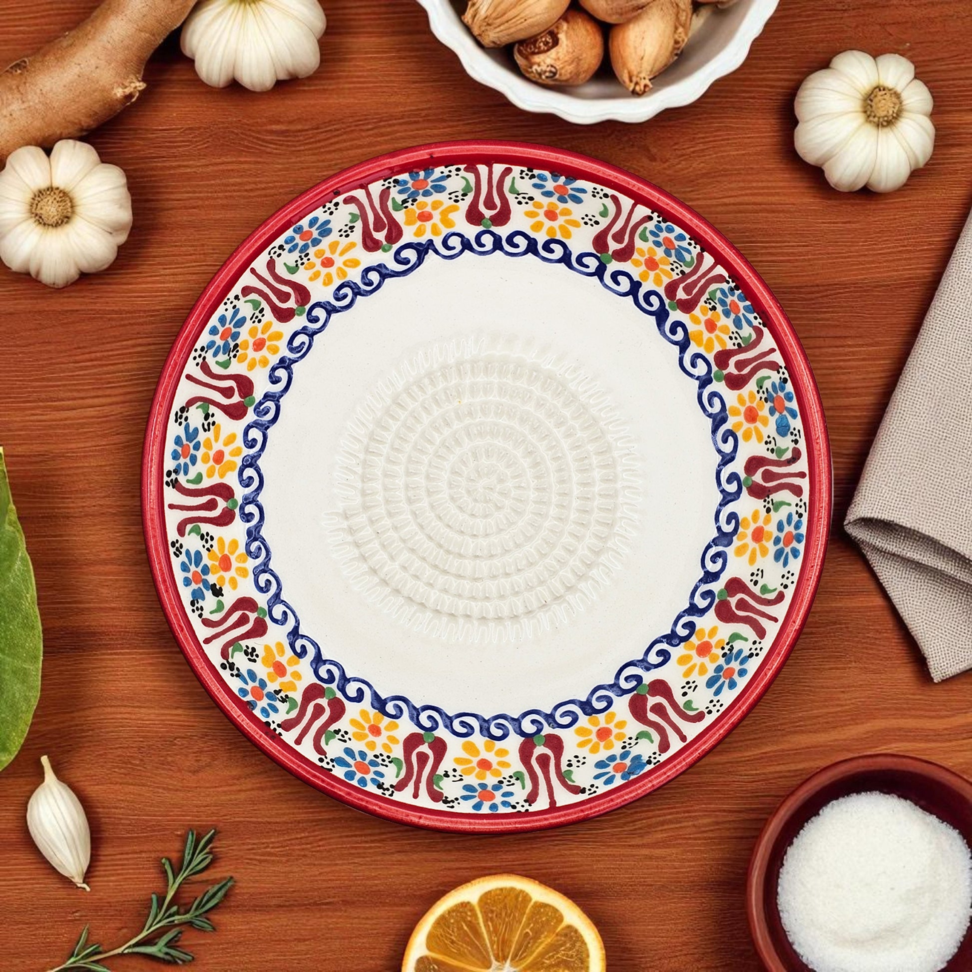 Decorative garlic grater bowl with colorful on a wooden table with ingredients