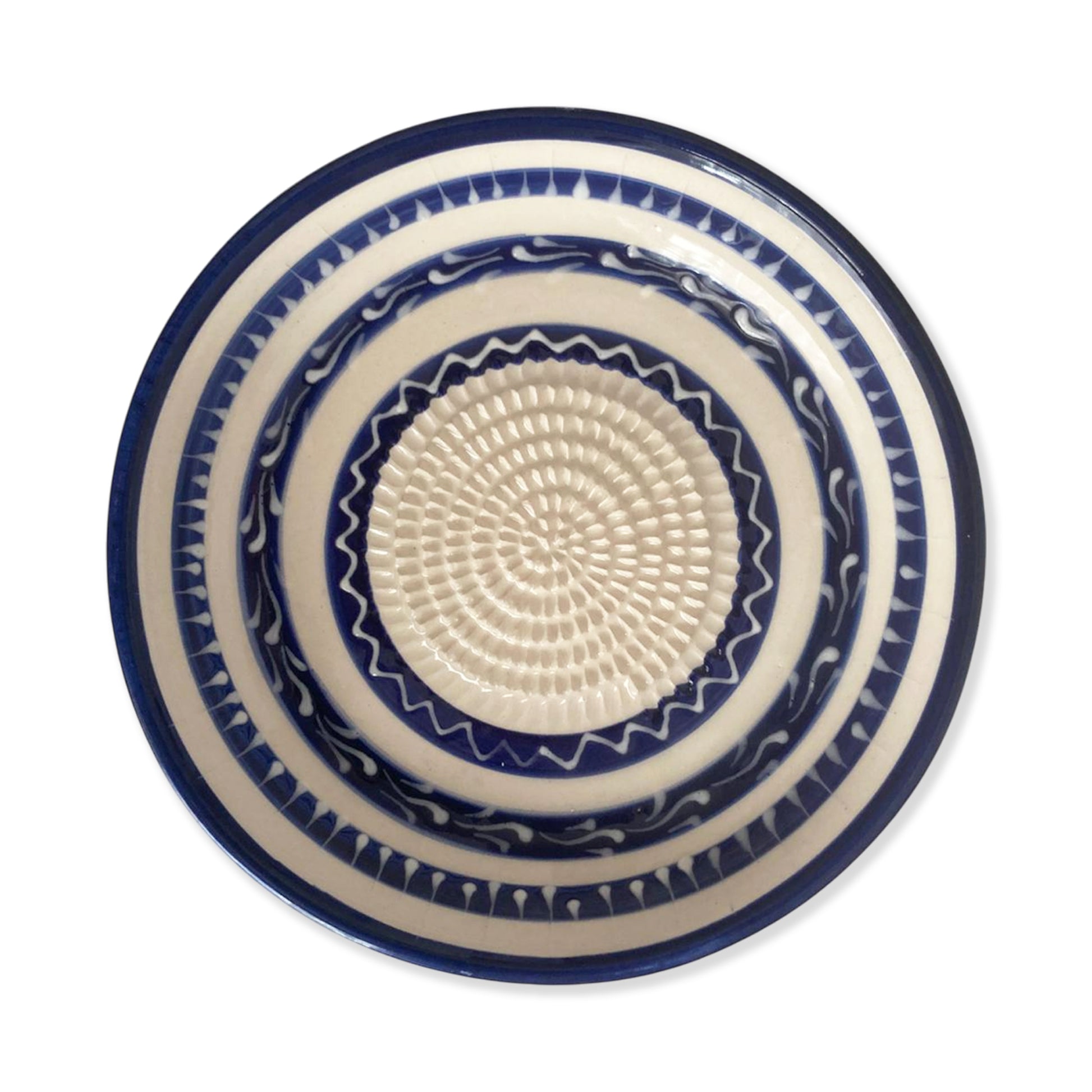 Ceramic garlic grater bowl with blue and white pattern on a white background