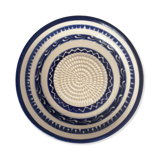 Ceramic garlic grater bowl with blue and white pattern on a white background