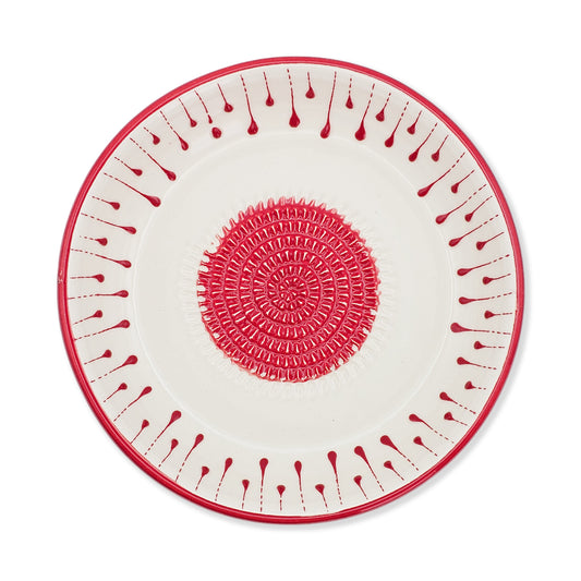 Decorative garlic grater bowl with red and white pattern on a white background