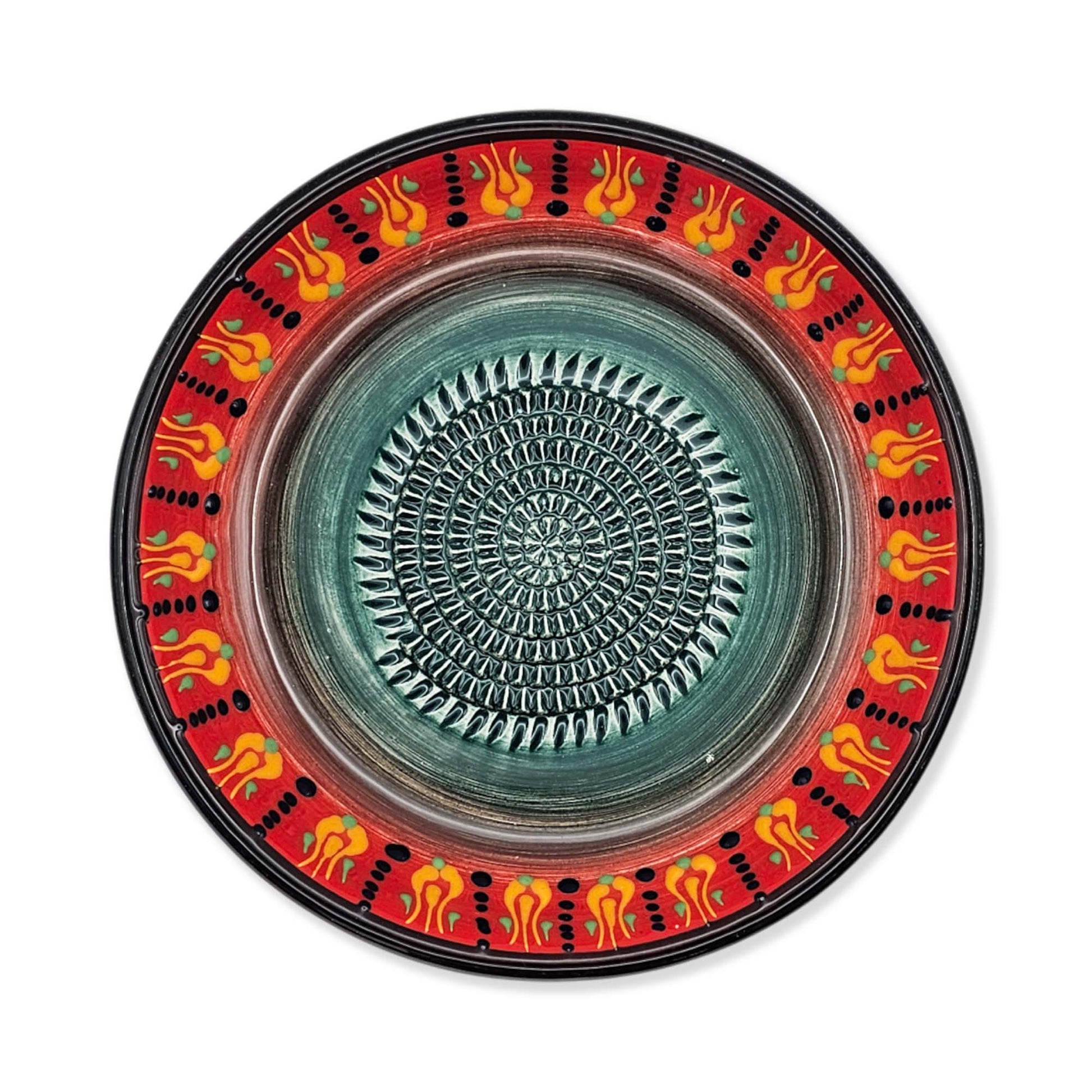 Decorative garlic grater bowl with a colorful rim and textured center on a white background