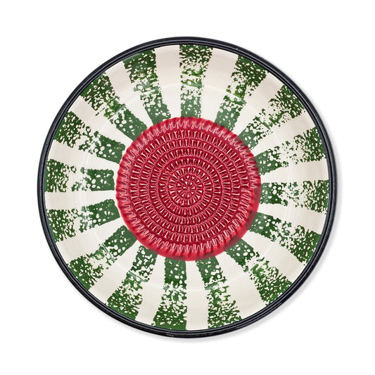 Round garlic grater bowl with a red center and green and white patterned rim on a white background