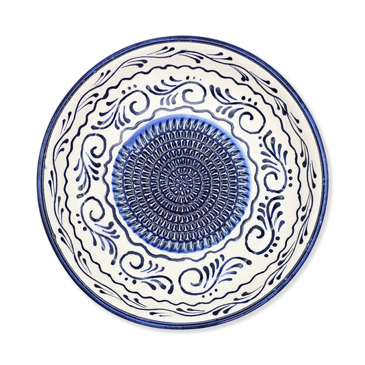 Ceramic garlic grater bowl with blue and white decorative patterns on a white background