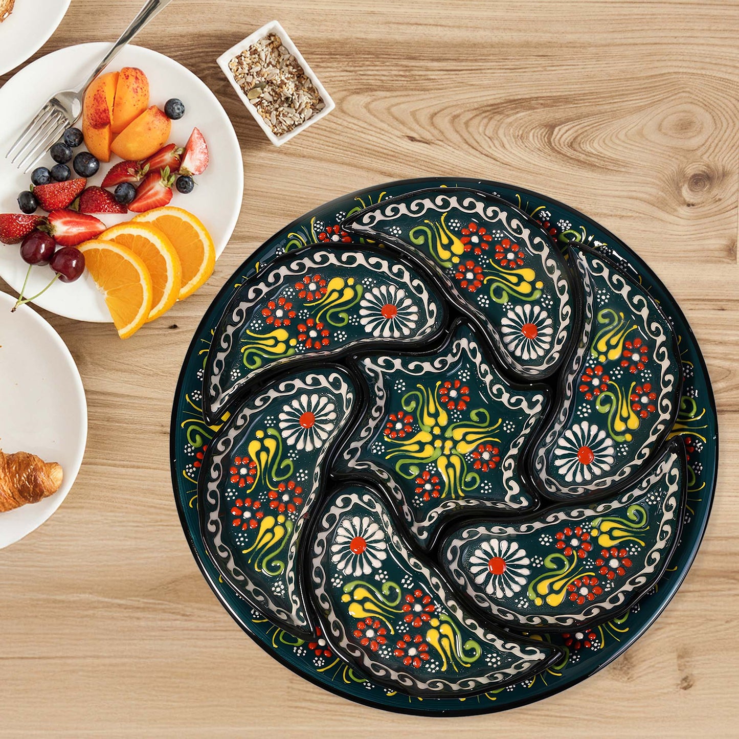 Decorative snack serving tray set with colorful paisley design on a wooden table with breakfast items.