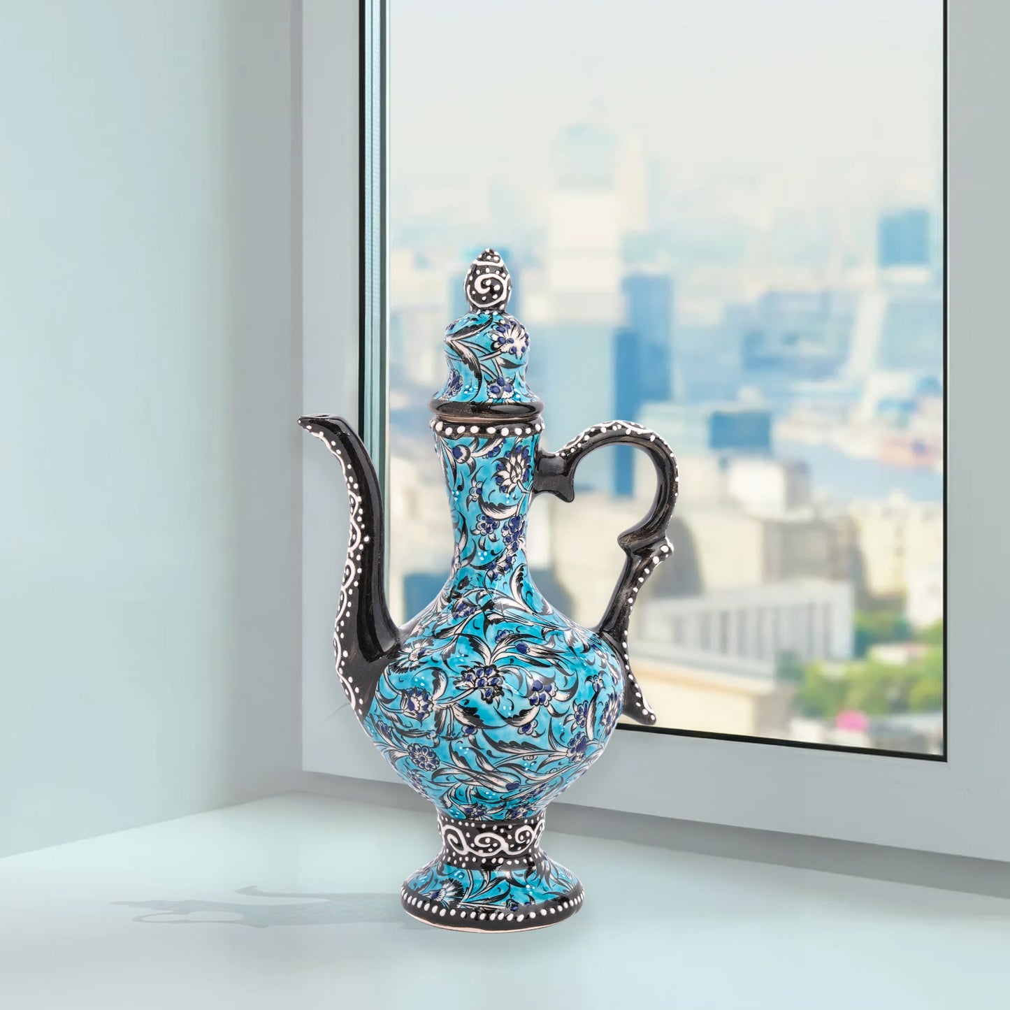 Hand-painted turquoise Ottoman-style ceramic ewer with floral motifs, curved spout & sculptural handle. Decorative artisan piece, perfect décor or gift.