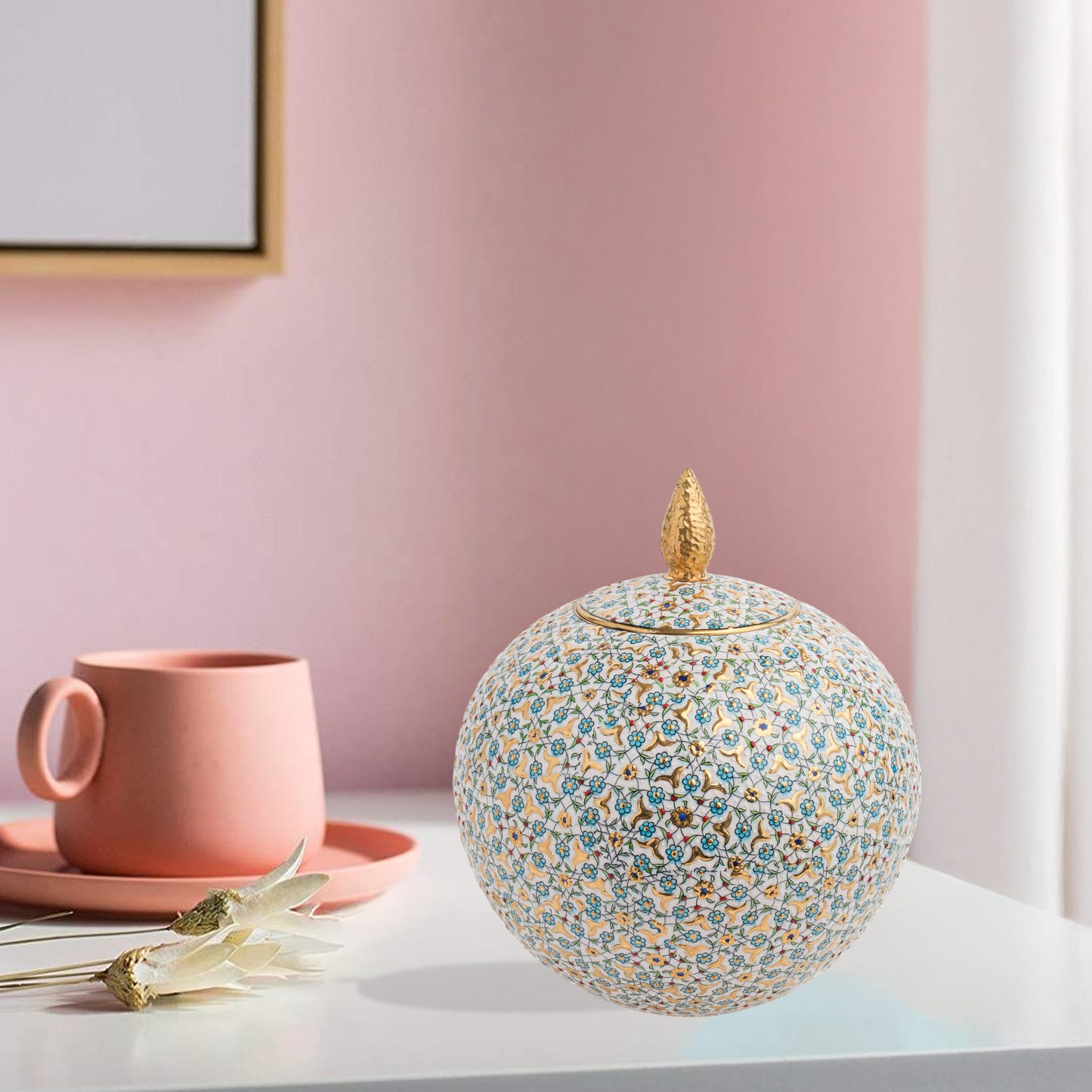 Hand-painted Floral Globe ceramic jar with blue blossoms and golden vines. Spherical artisan design with gold finial, perfect for décor or luxury gifting.