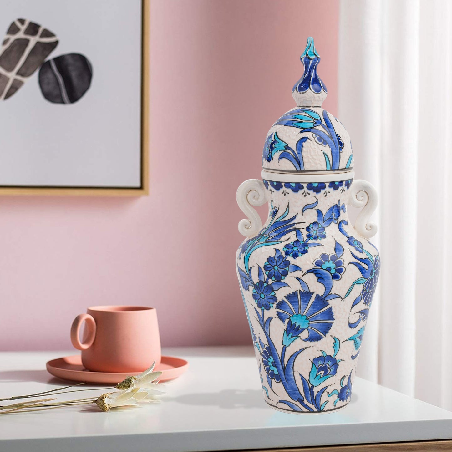 Hand-painted Azure Blossom ceramic jar with Turkish blue floral motifs and turquoise accents. Features handles and finial lid, perfect décor or collector’s gift.