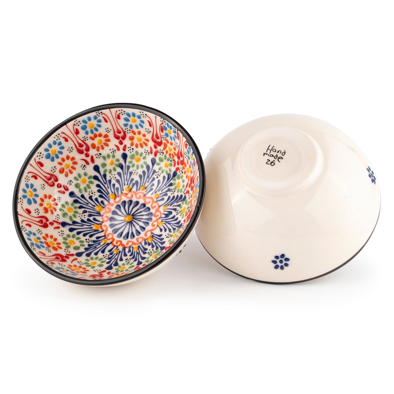 A set of two ceramic serving bowls, one with a colorful floral pattern and one with a plain vanilla white exterior.