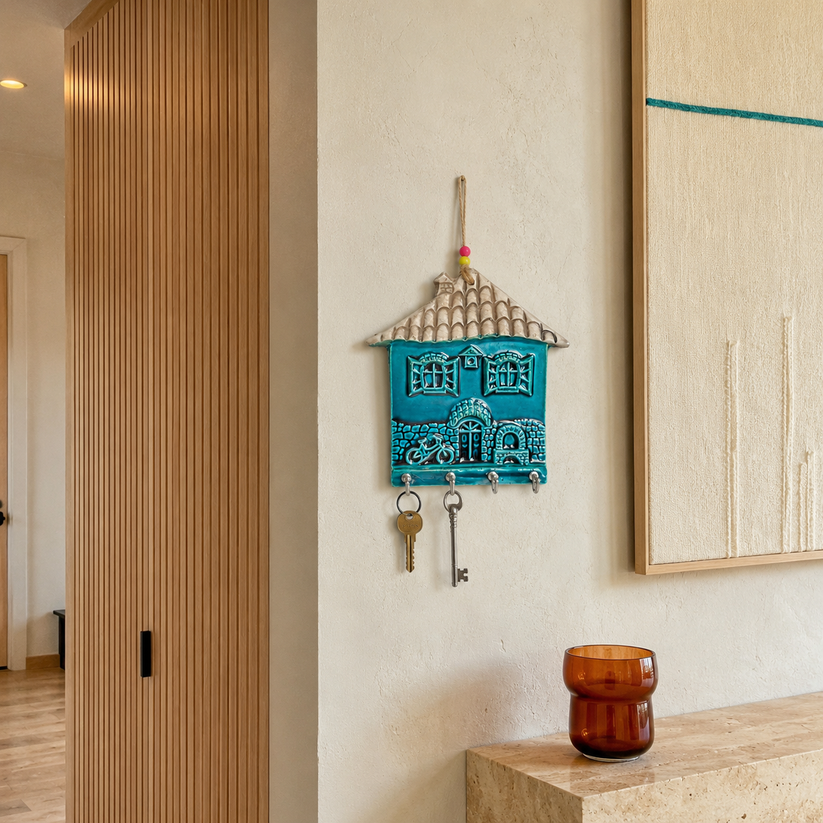 Handmade ceramic house key holder organizing keys in a modern hallway