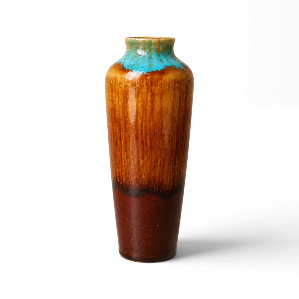 Tall ceramic vase with a gradient from brown to blue on a white background