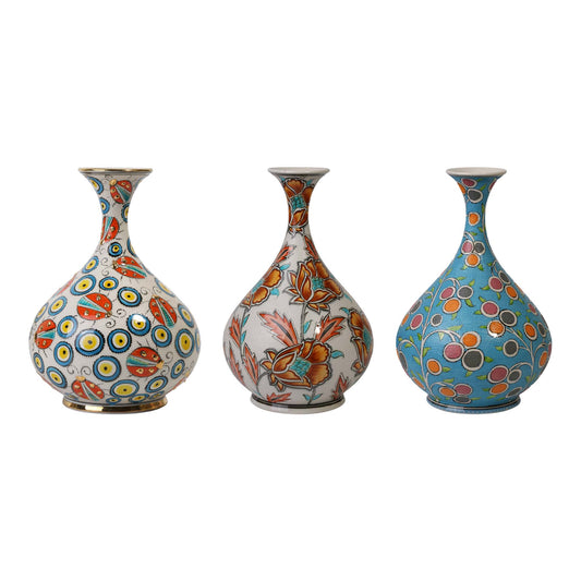 Three decorative ceramic vases with floral patterns on a white background