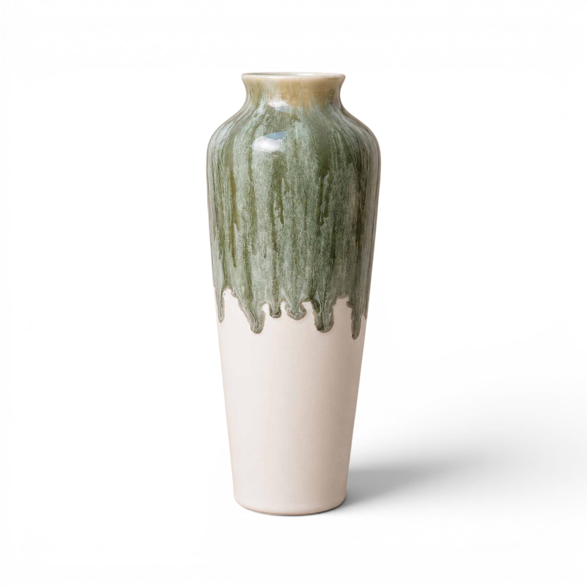 Ceramic vase with green and white glaze on a white background
