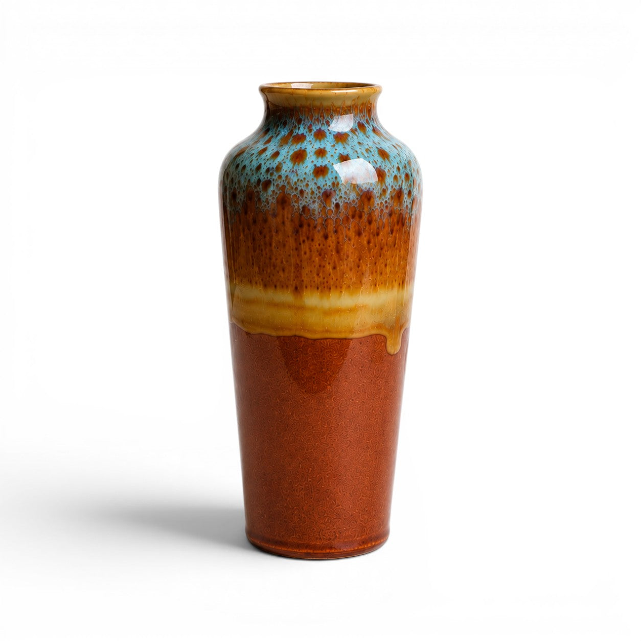 Ceramic vase with gradient glaze from brown to blue on a white background