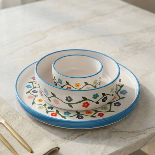 Set of ceramic dishes with floral patterns on a marble surface