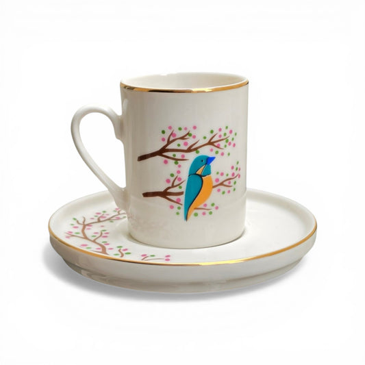 Porcelain cup and saucer set with a bird design on a white background