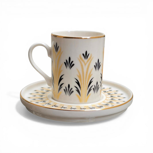 Porcelain mug and saucer with decorative patterns on a white background