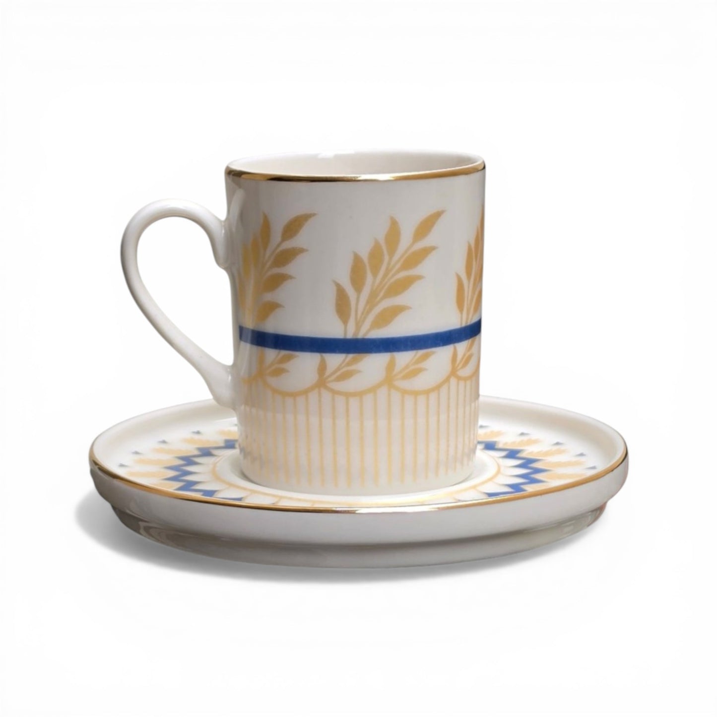 Porcelain cup and saucer with gold leaf patterns and blue stripes on a white background