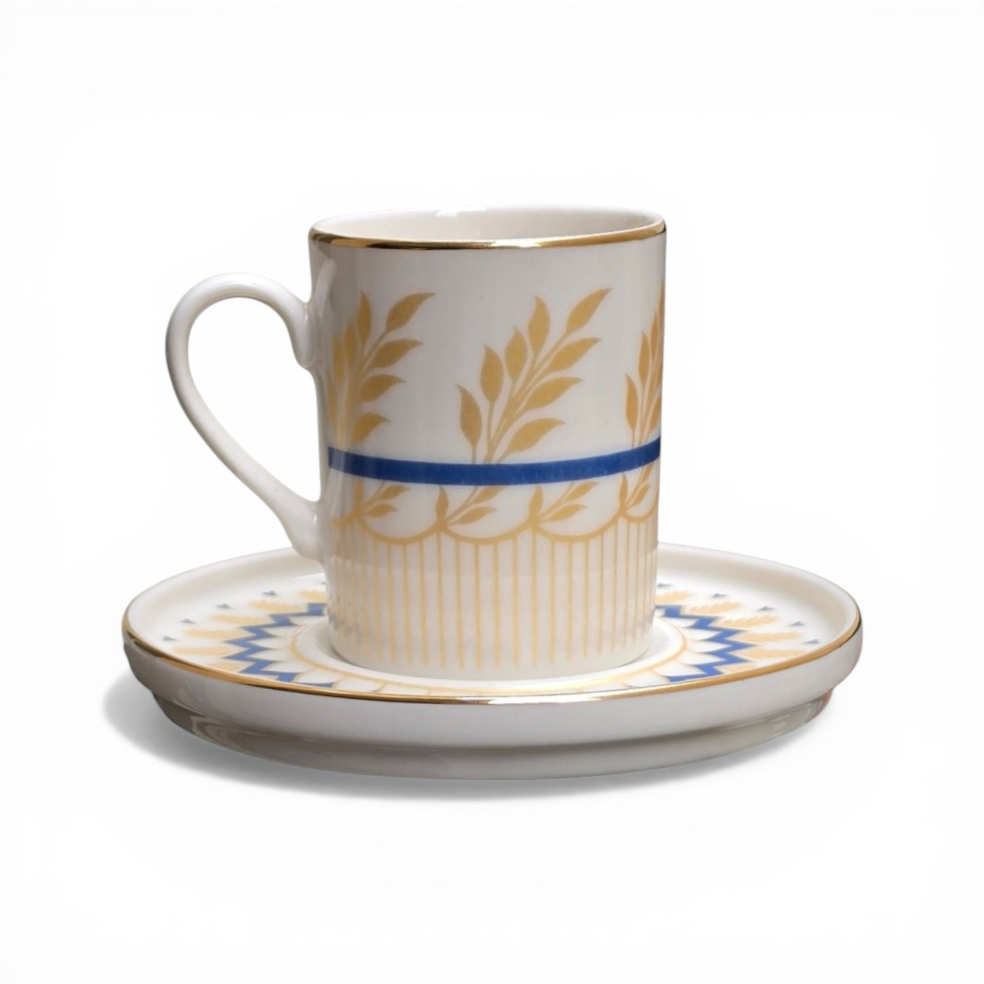 Porcelain cup and saucer with gold leaf patterns and blue stripes on a white background