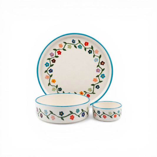 Ceramic dinnerware set with floral design on a white background
