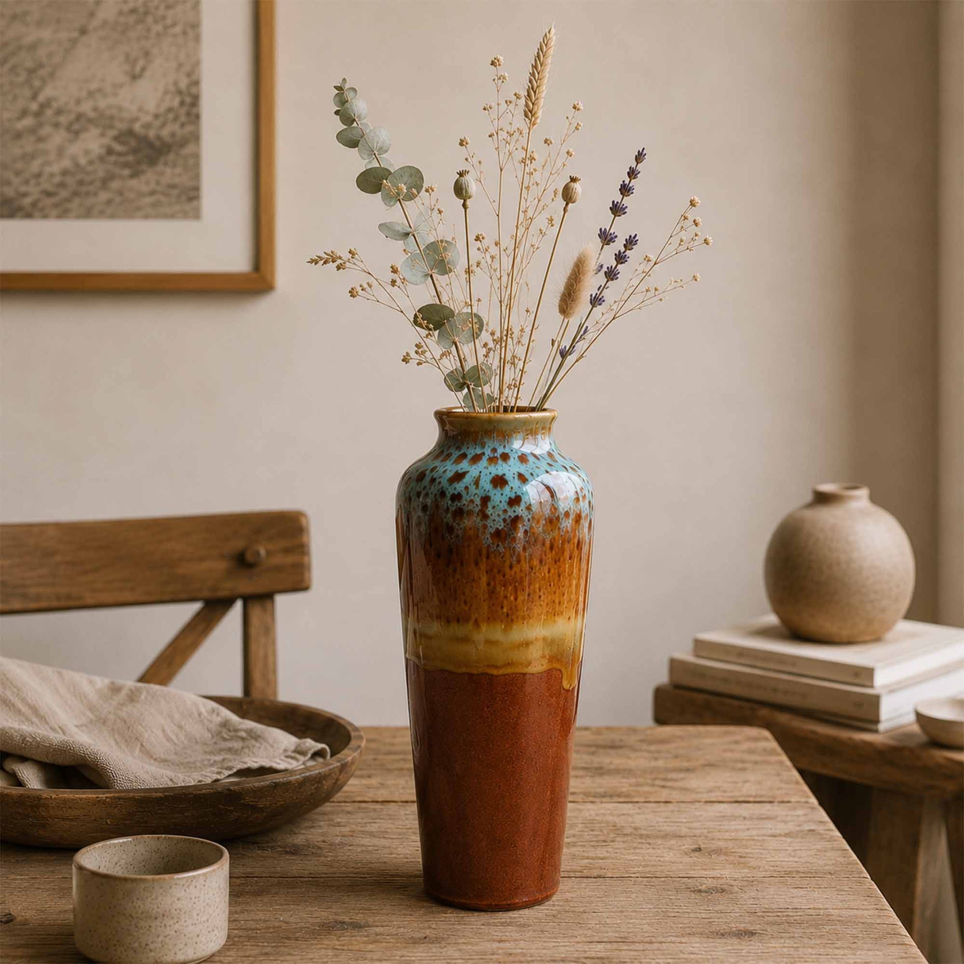 Decorative ceramic vase with multicolored glaze on a wooden table with a neutral background