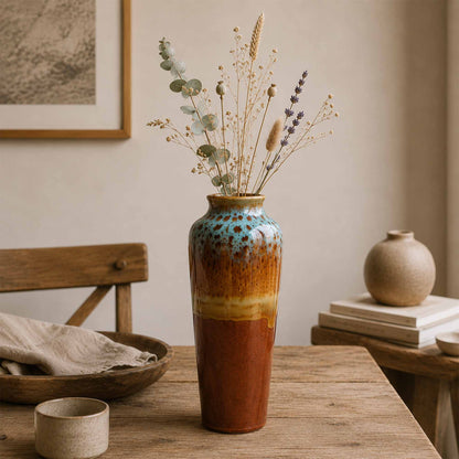 Decorative ceramic vase with multicolored glaze on a wooden table with a neutral background