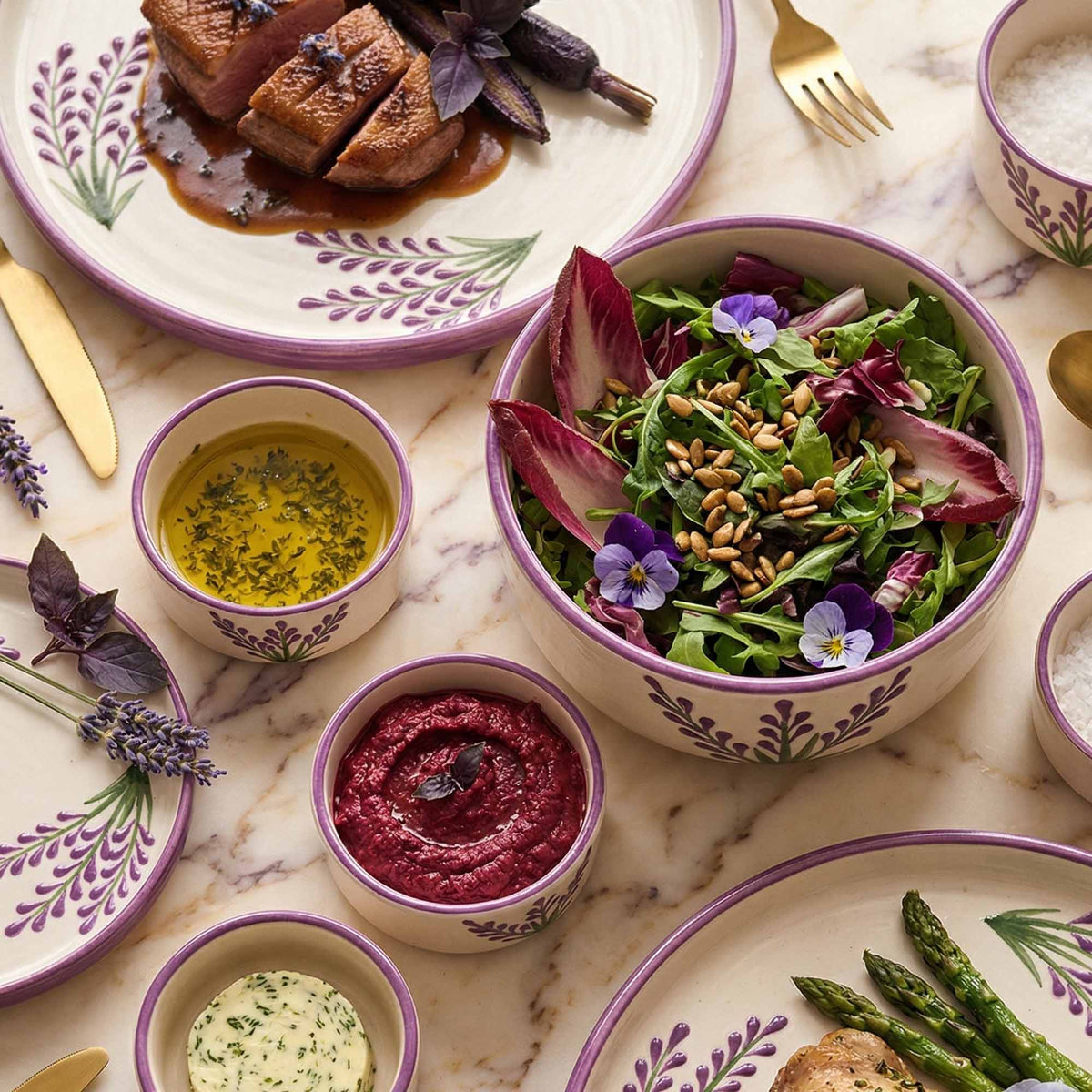 Dinner setting with roasted duck, salad, and side dishes on a marble table.