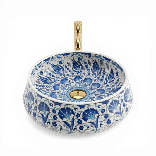 Decorative ceramic sink with blue floral patterns and gold accents on a white background