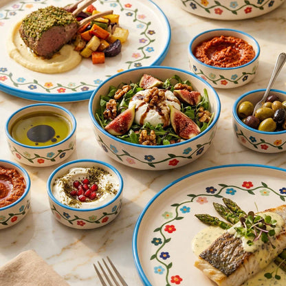 Diverse meal setup with plates, bowls, and utensils on a marble surface