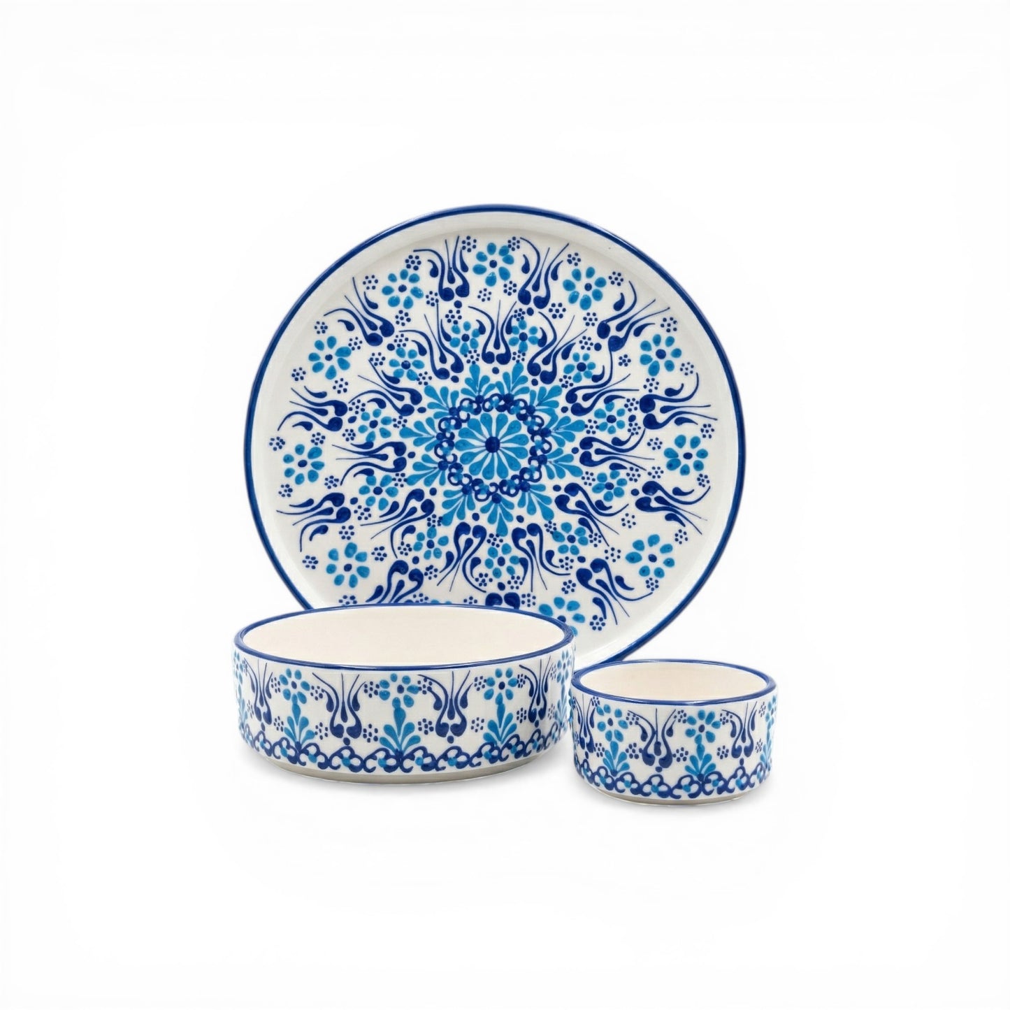 Ceramic plate, bowl, and cup set with blue floral patterns on a white background