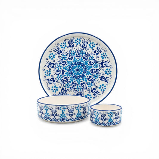 Ceramic plate, bowl, and cup set with blue floral patterns on a white background