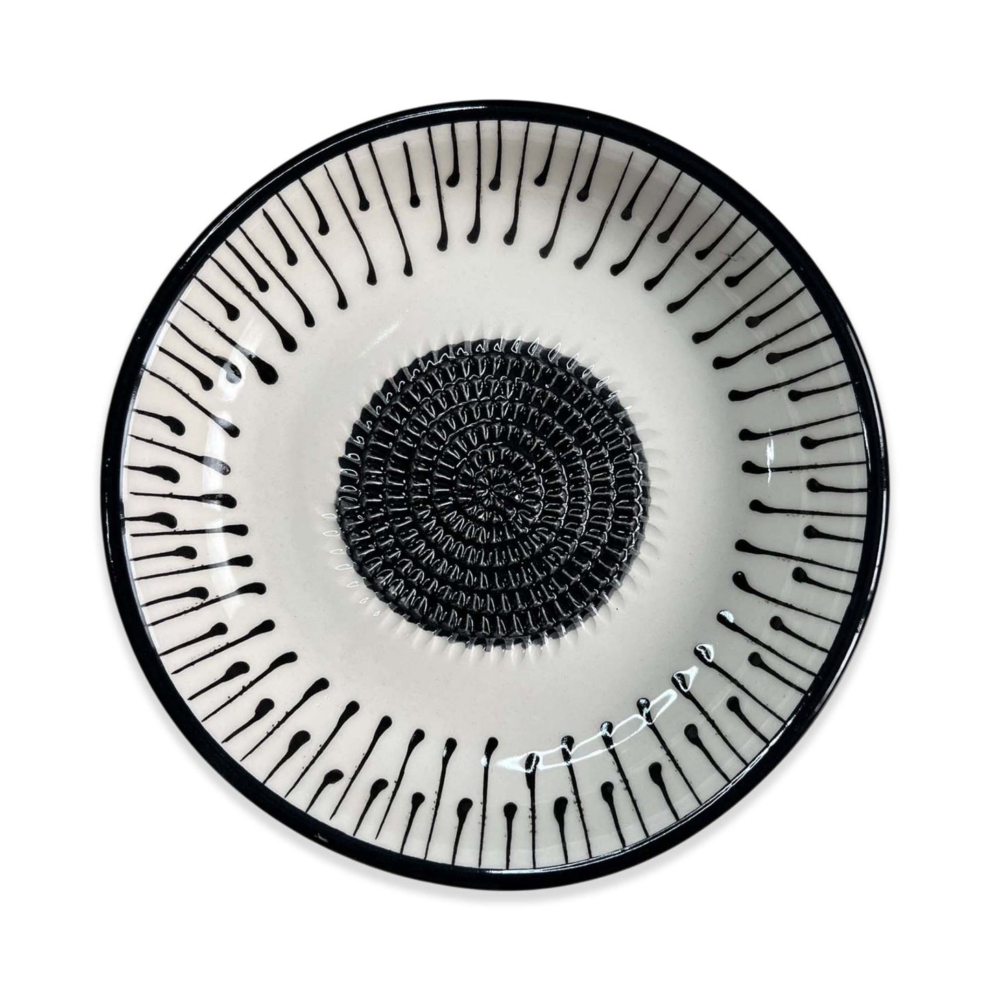 Decorative garlic grater bowl with black spiral design on a white background