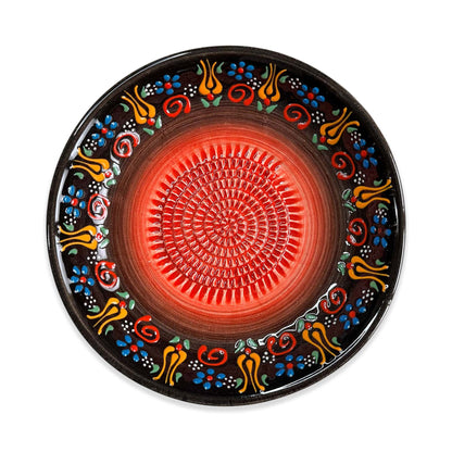 Decorative garlic grater bowl with colorful patterns on a white background