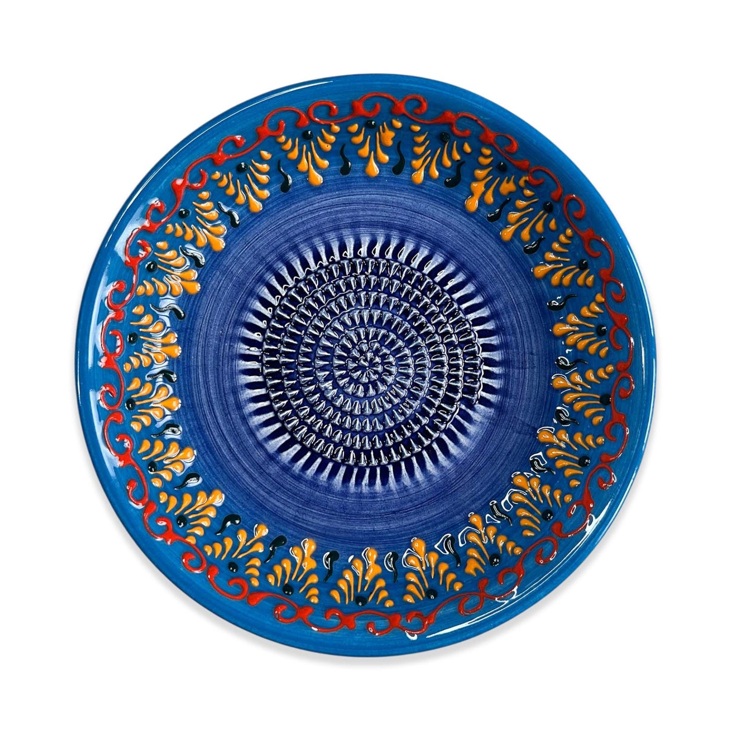 Decorative blue garlic grater bowl with intricate patterns on a white background