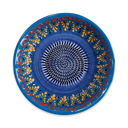 Decorative blue garlic grater bowl with intricate patterns on a white background