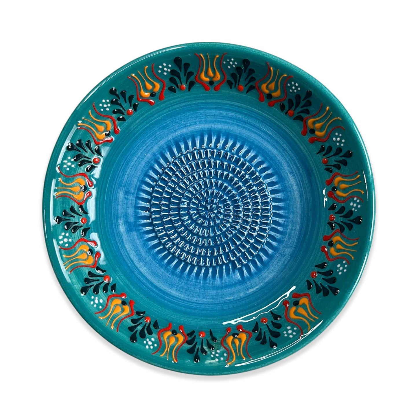 Decorative blue garlic grater bowl with colorful patterns on a white background