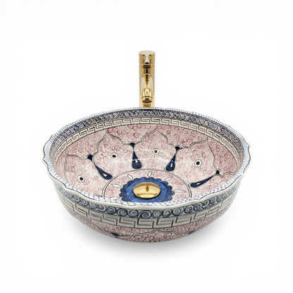 Decorative ceramic sink with artistic design on a white background