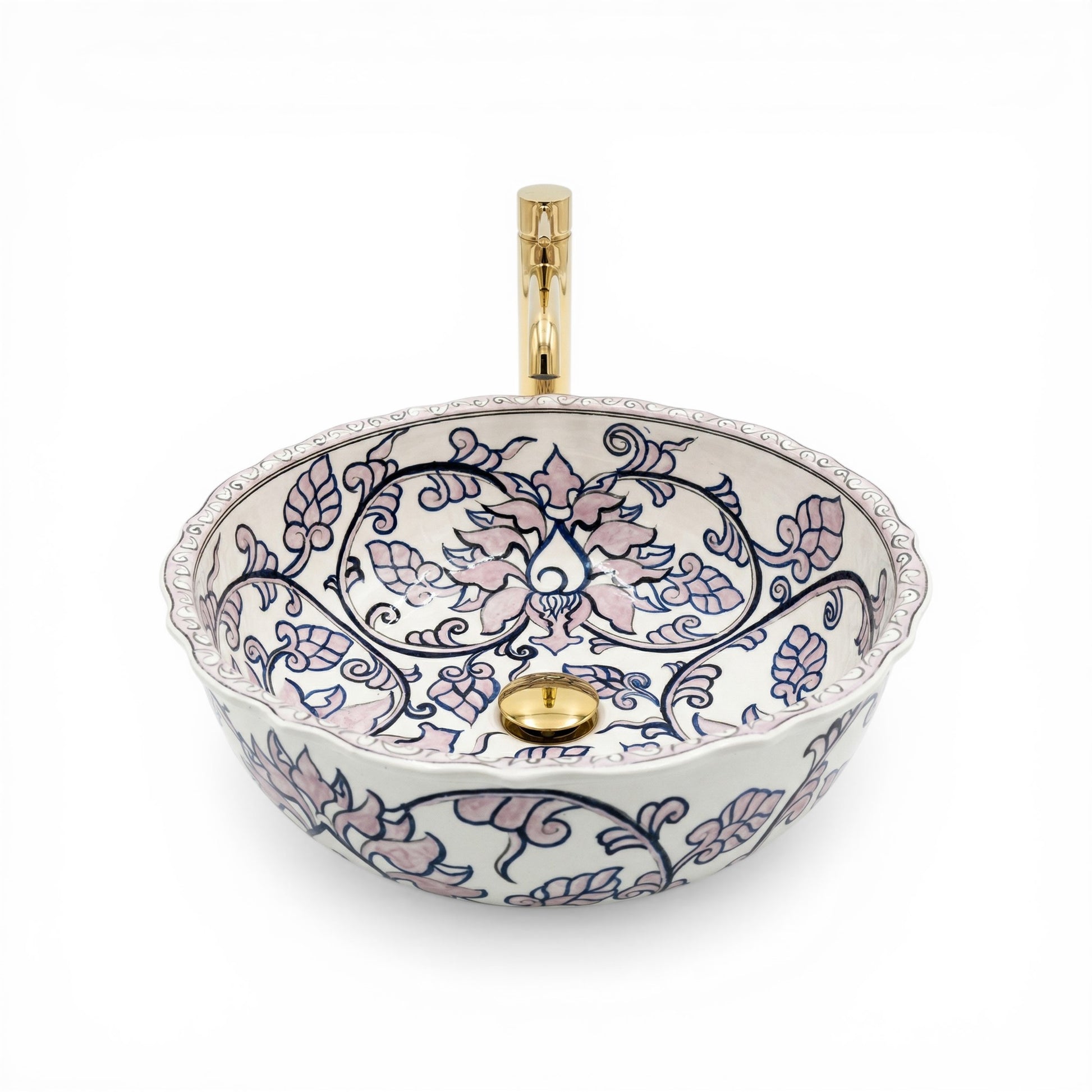 Decorative ceramic sink with floral patterns and gold accents on a white background