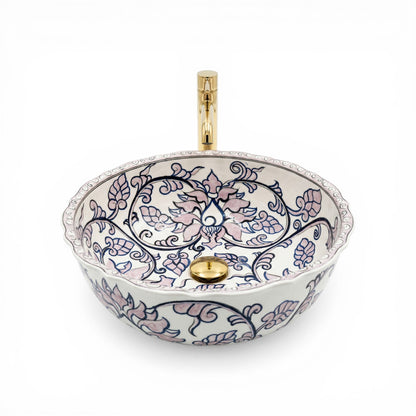Decorative ceramic sink with floral patterns and gold accents on a white background