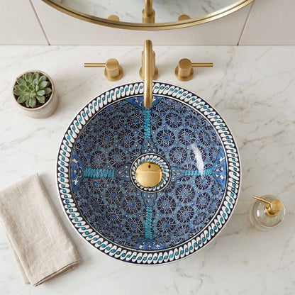 Decorative blue and gold sink with a marble countertop