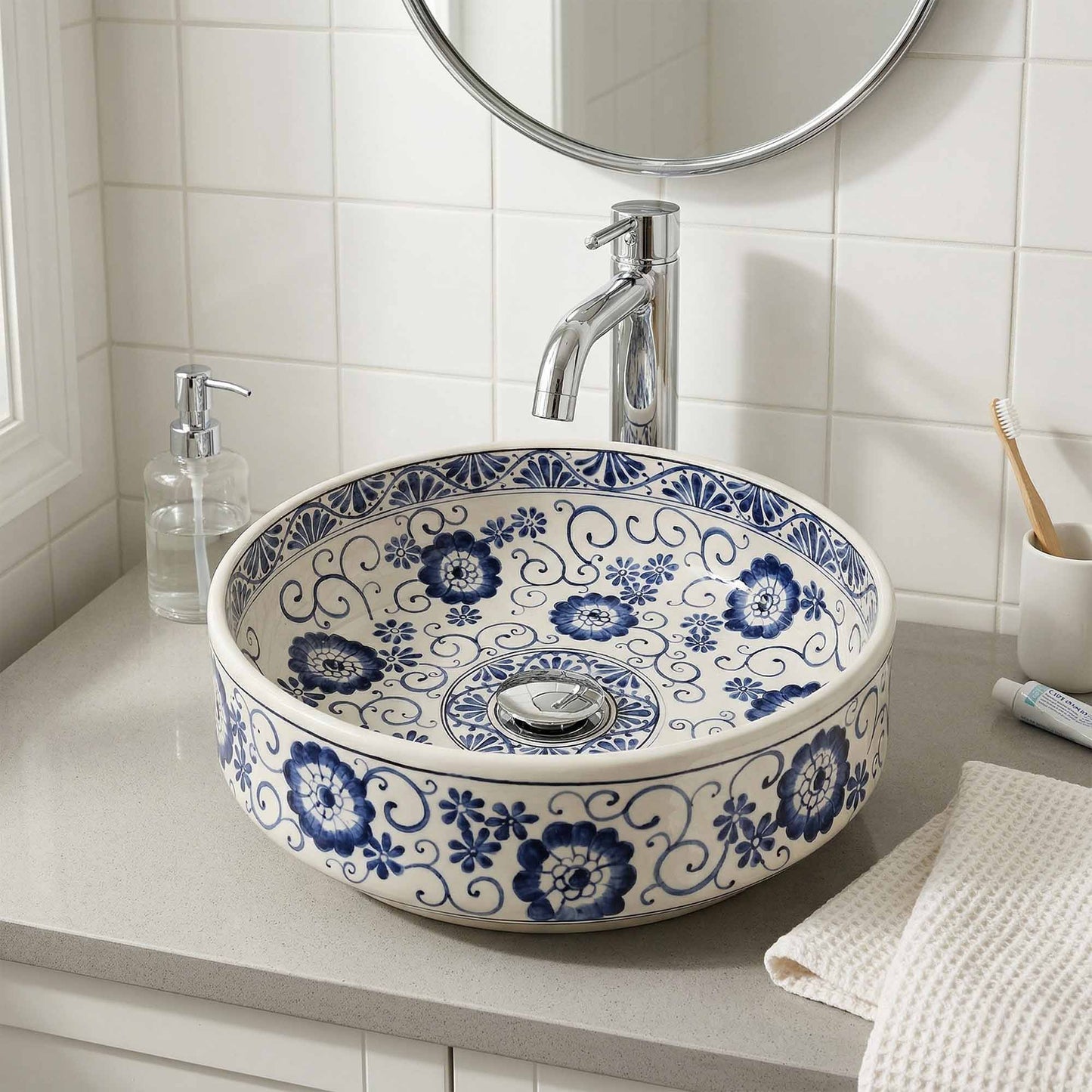 Bathroom sink with blue floral pattern, silver faucet, and toiletries.