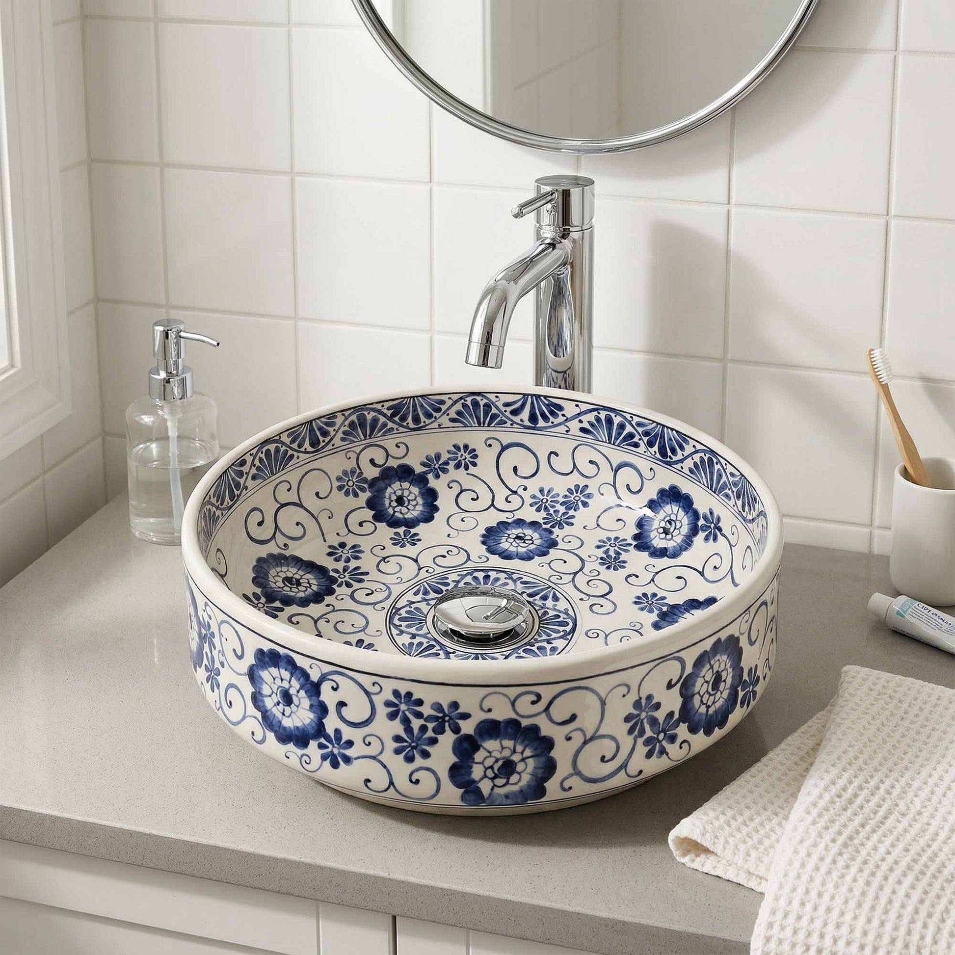 Bathroom sink with blue floral pattern, silver faucet, and toiletries.