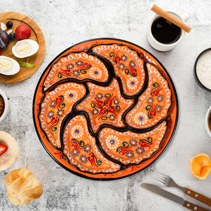 Decorative snack serving tray set with a floral design on a table with food and coffee.
