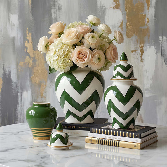 Green and white chevron-patterned jars with flowers on a marble surface against a textured wall.