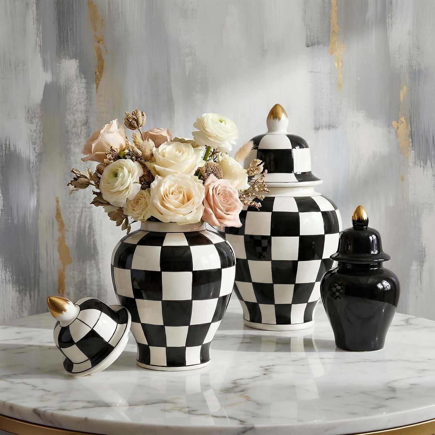 Decorative black and white checkered vases with floral arrangements on a marble surface.