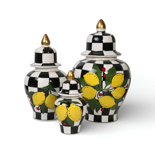 Set of three decorative jars with lemon designs on a white background