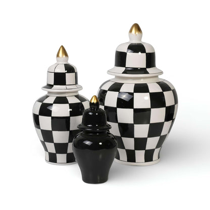 Set of three black and white checkered ceramic jars with gold accents on a white background