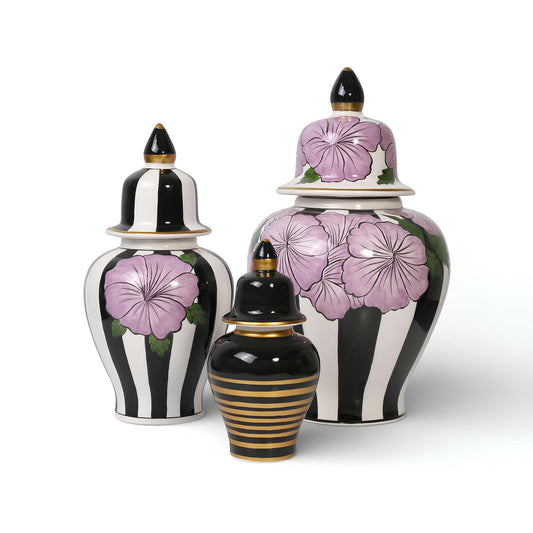 Set of decorative ceramic jars with floral designs on a white background